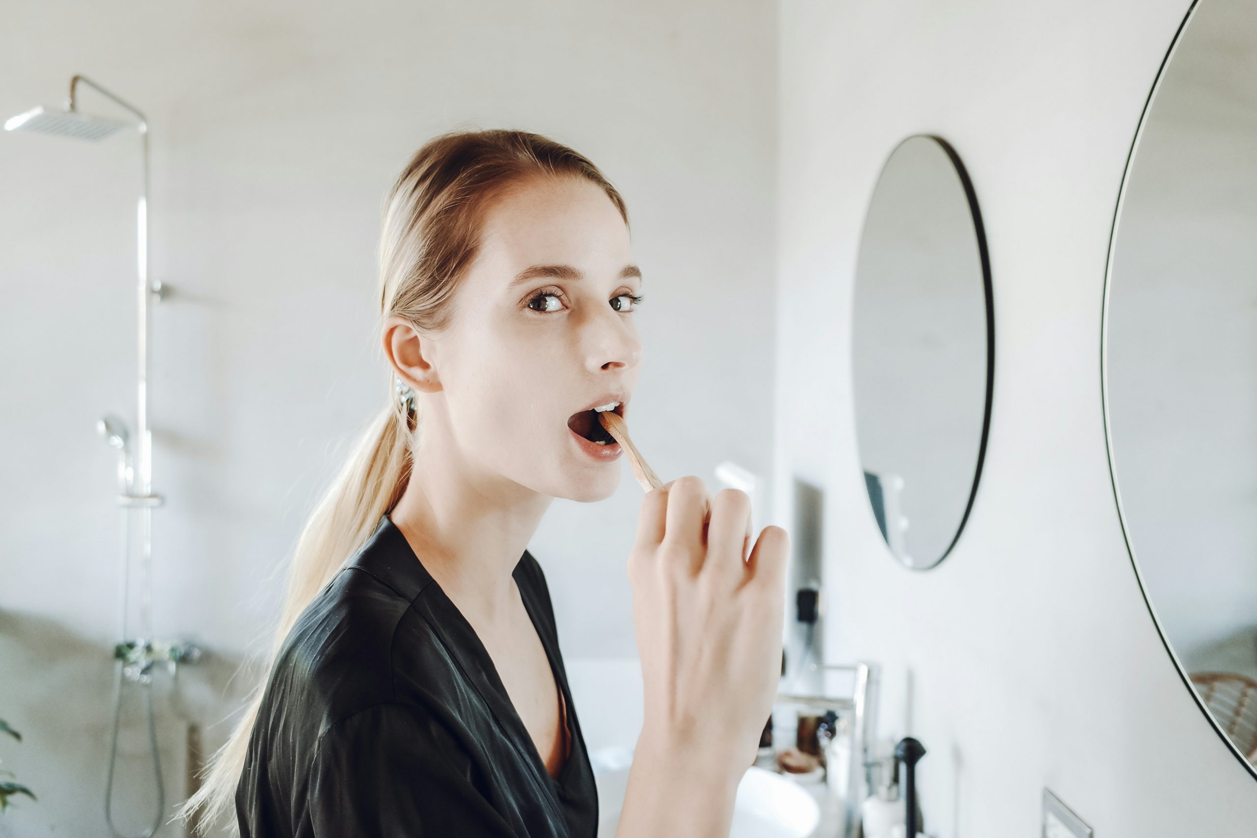 young woman brushing her teeth